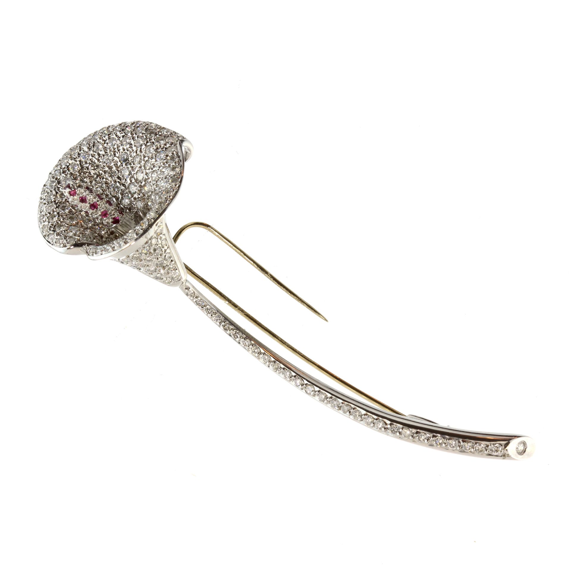 A jewelled diamond and ruby lily brooch in white gold or platinum designed as a Calla lily, the