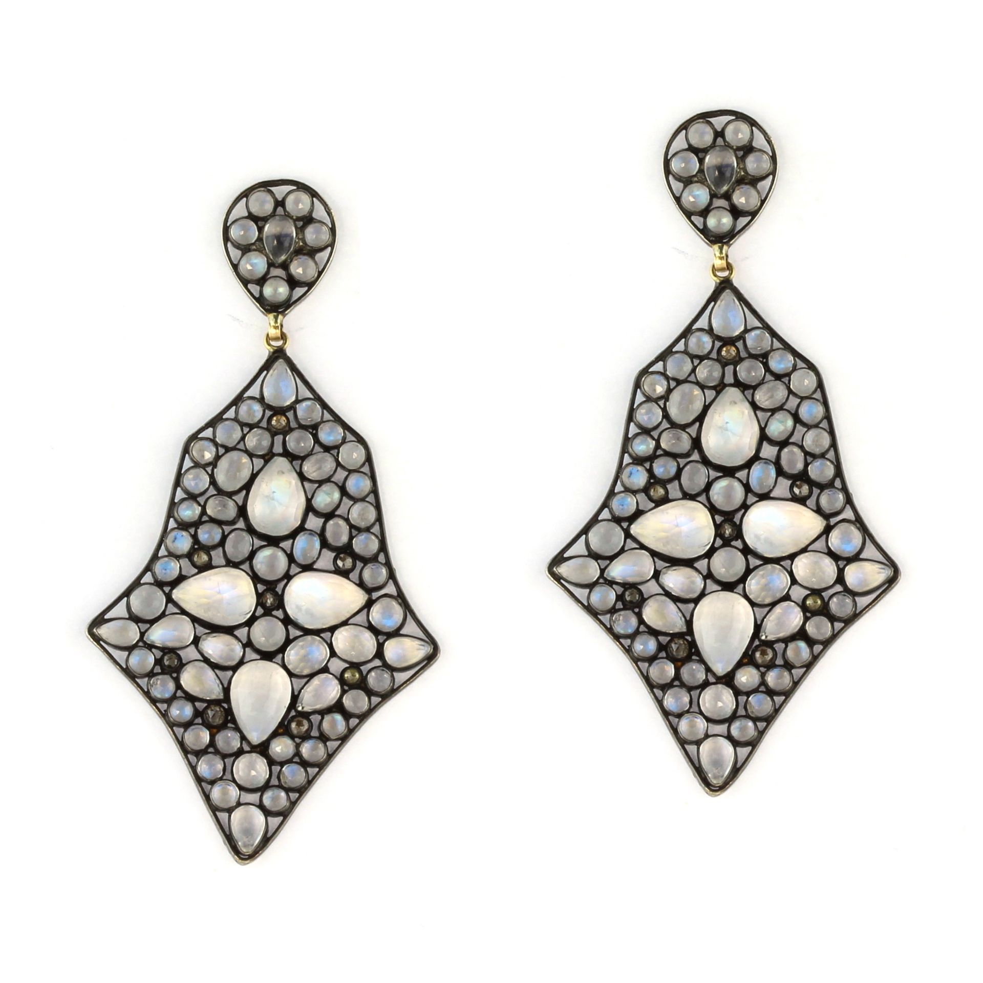 A pair of moonstone and diamond dress earrings each set with four principal pear shaped rose cut