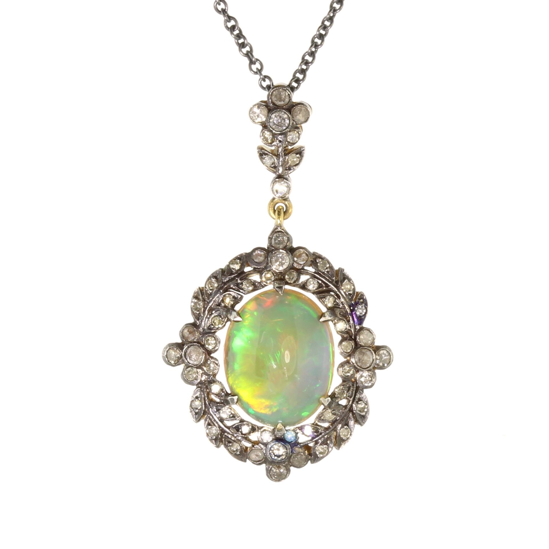 An antique opal and diamond pendant and chain in gold set with a central oval cabochon opal of