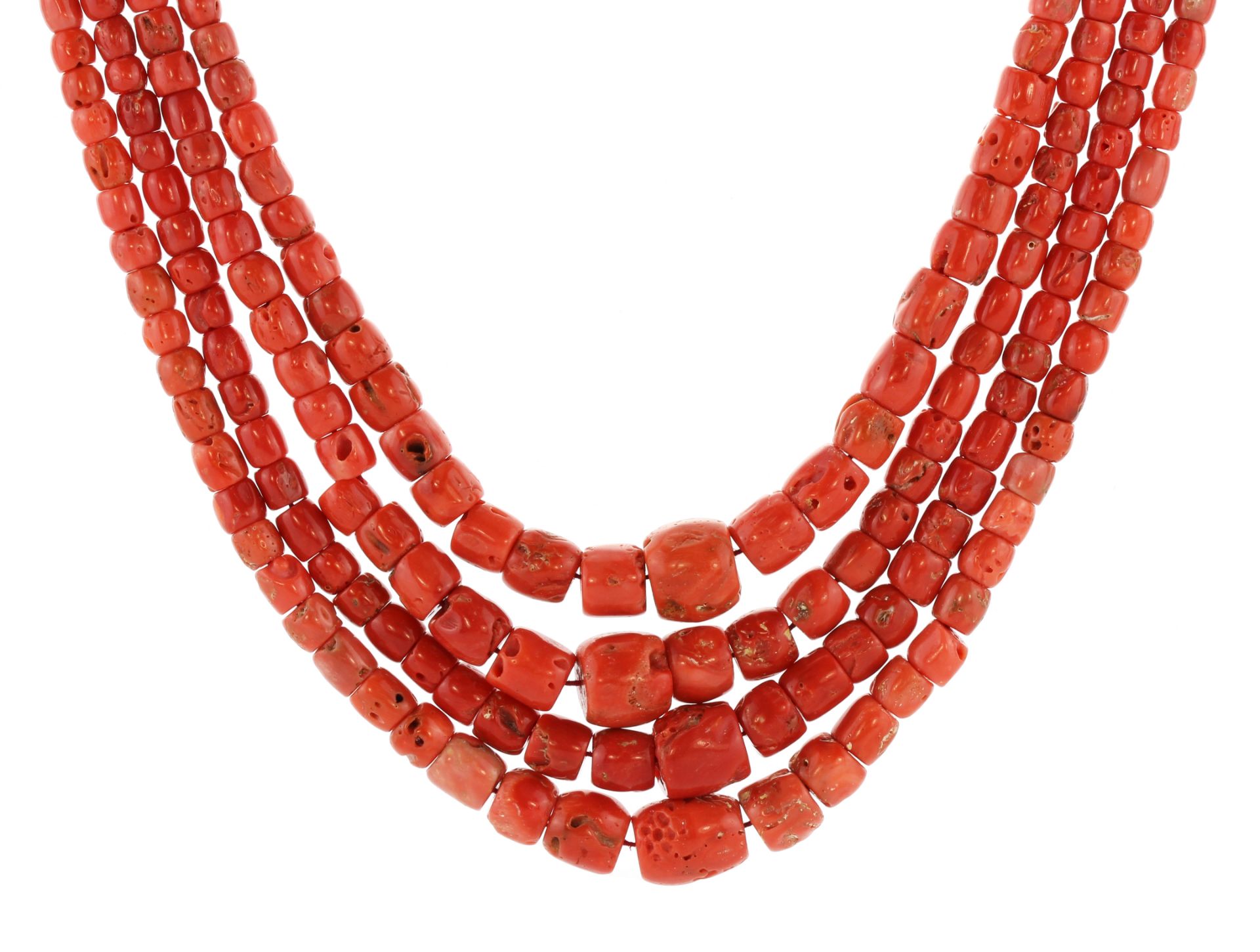 A large, naturalistic coral bead necklace comprising four strands of graduated coral beads. Length