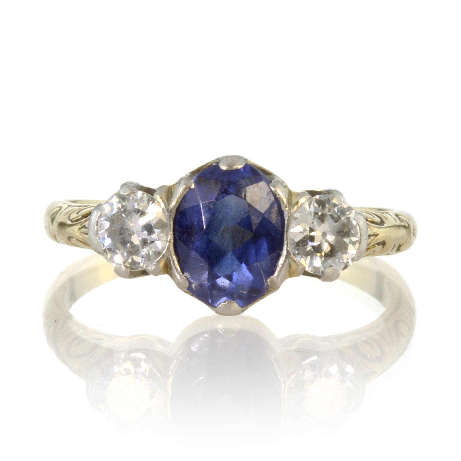 A sapphire and diamond three stone dress ring in 14ct yellow gold set with a central oval cut blue