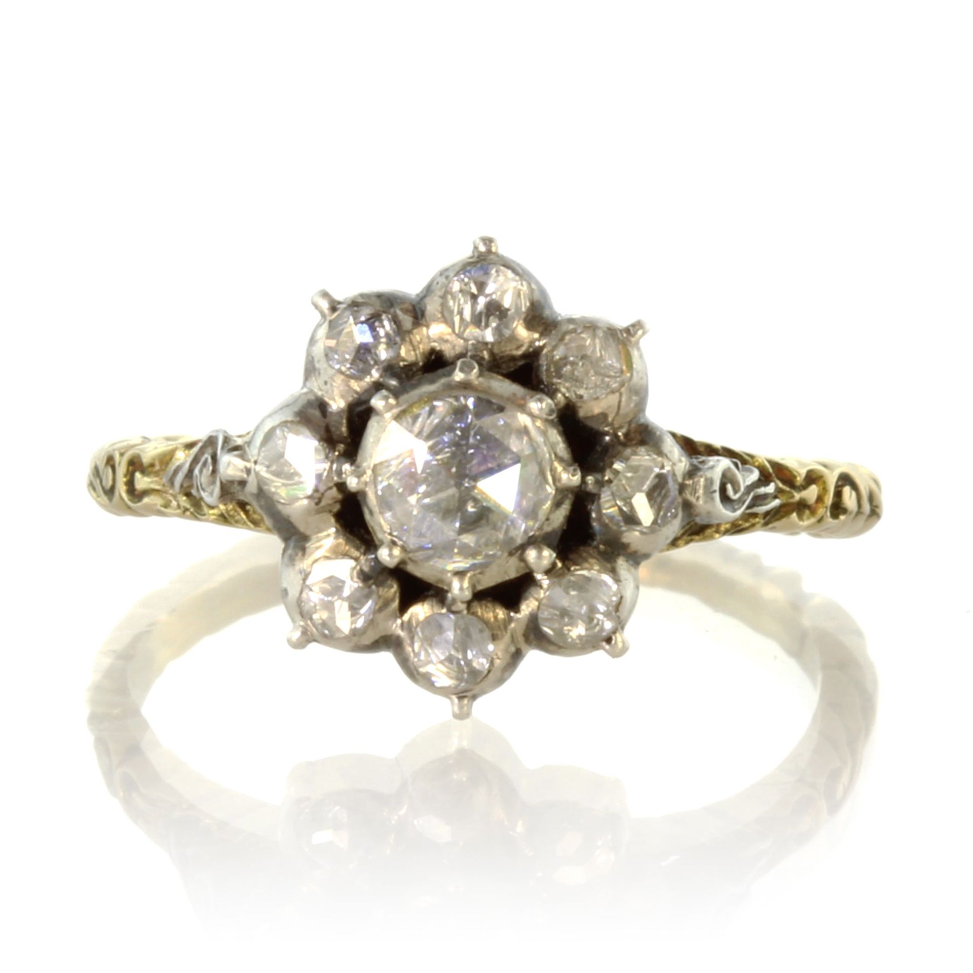 An antique diamond cluster dress ring in high carat yellow gold set with a central rose cut