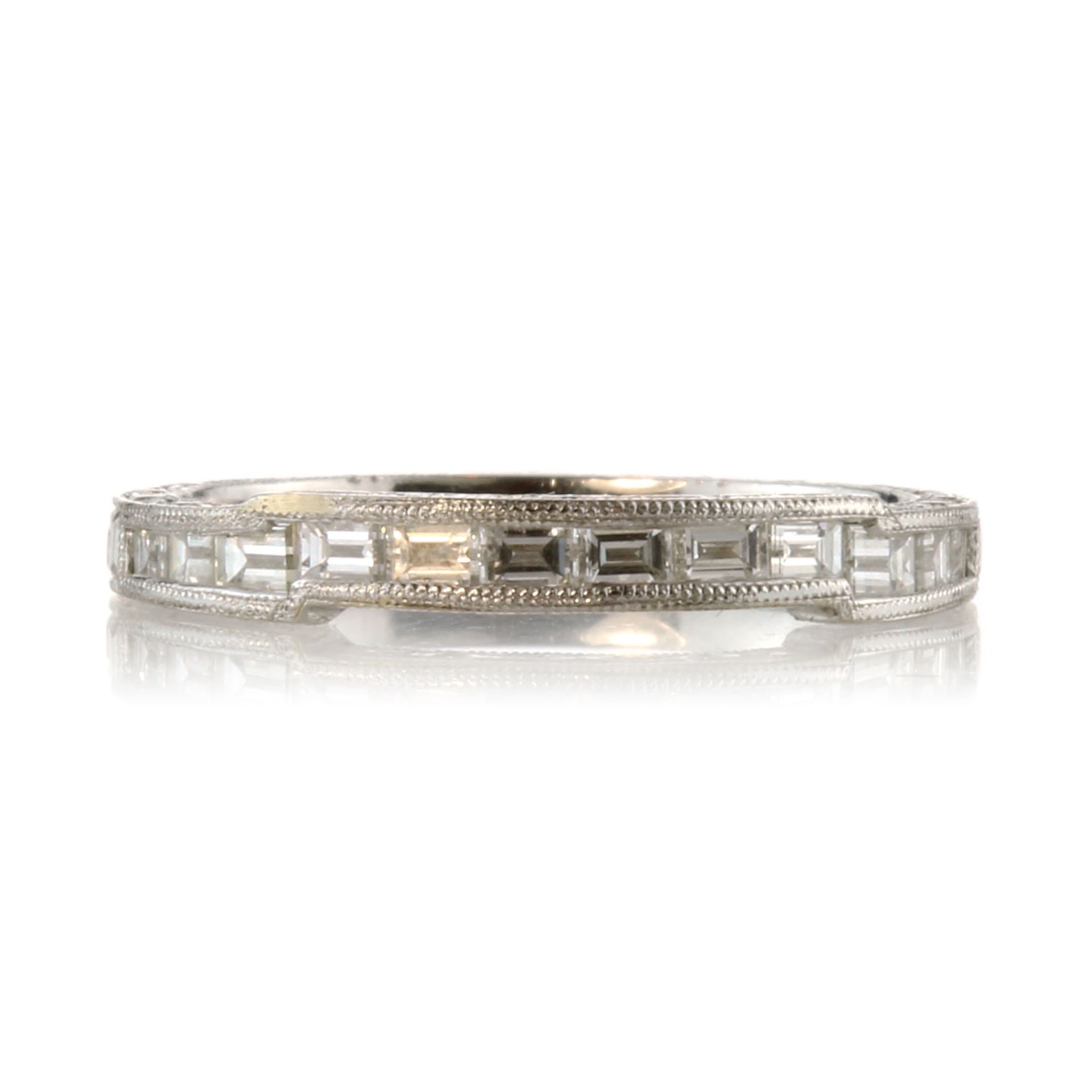 A diamond half eternity band ring in 18ct white gold set with twelve baguette cut diamonds totalling