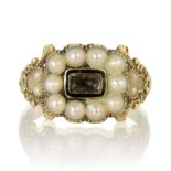 An antique Georgian hairwork and pearl mourning ring in 18ct yellow gold set with a central