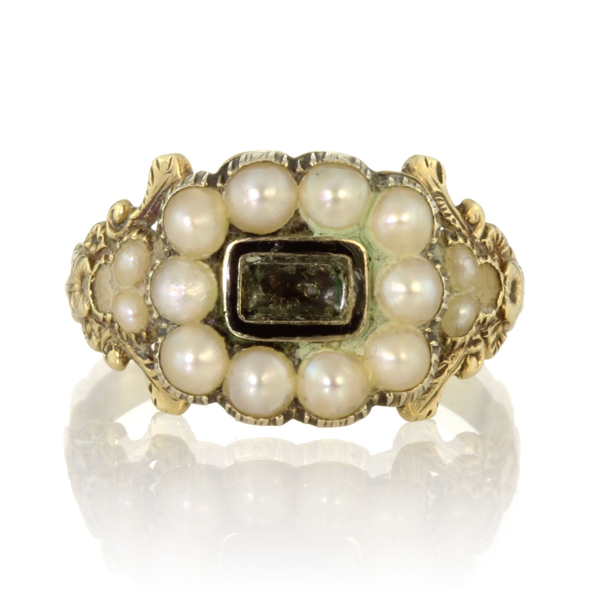 An antique Georgian hairwork and pearl mourning ring in 18ct yellow gold set with a central