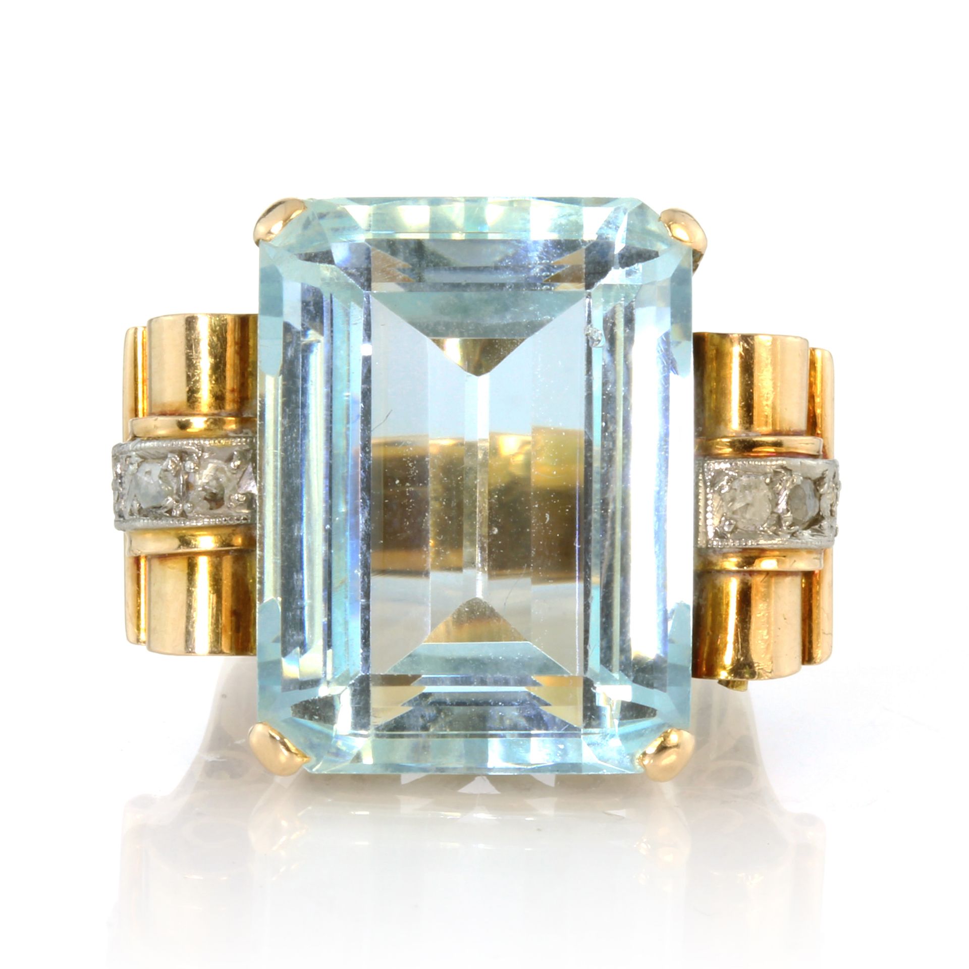 An antique Art Deco aquamarine and diamond dress ring in 18ct yellow gold set with a large emerald