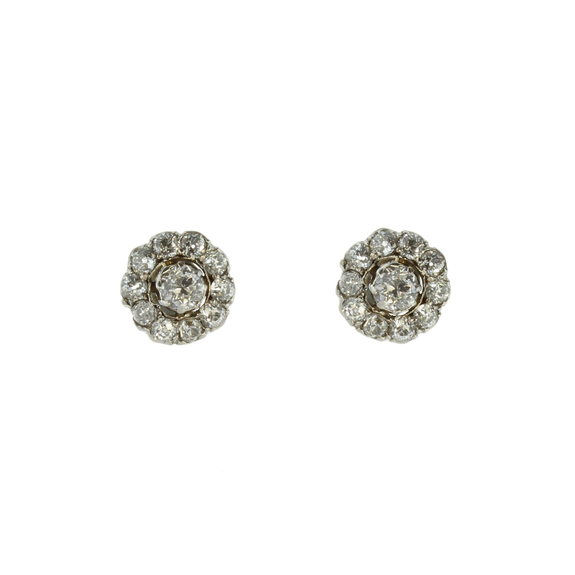 A pair of antique diamond cluster stud earrings in 18ct yellow gold and platinum, each set with a