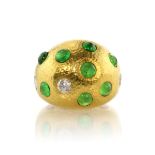 A vintage emerald and diamond bombe dress ring in 22ct yellow gold of bombe form with textured