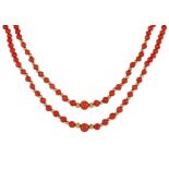A double row coral and gold bead necklace in yellow gold designed as two rows of two hundred and