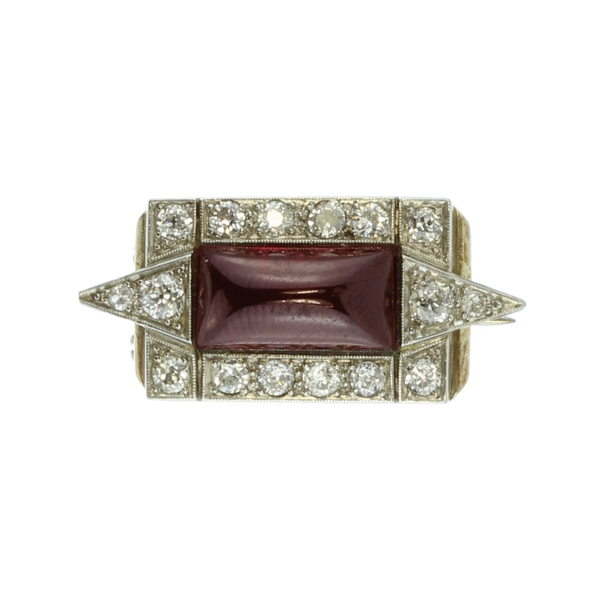 An antique garnet and diamond brooch in silver and high carat yellow gold set with a large,
