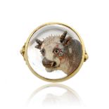 An antique Essex crystal / reverse intaglio cow ring in yellow gold set with a central circular