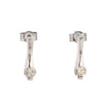 A pair of diamond drop earrings in 18ct white gold each set with a round cut diamond of