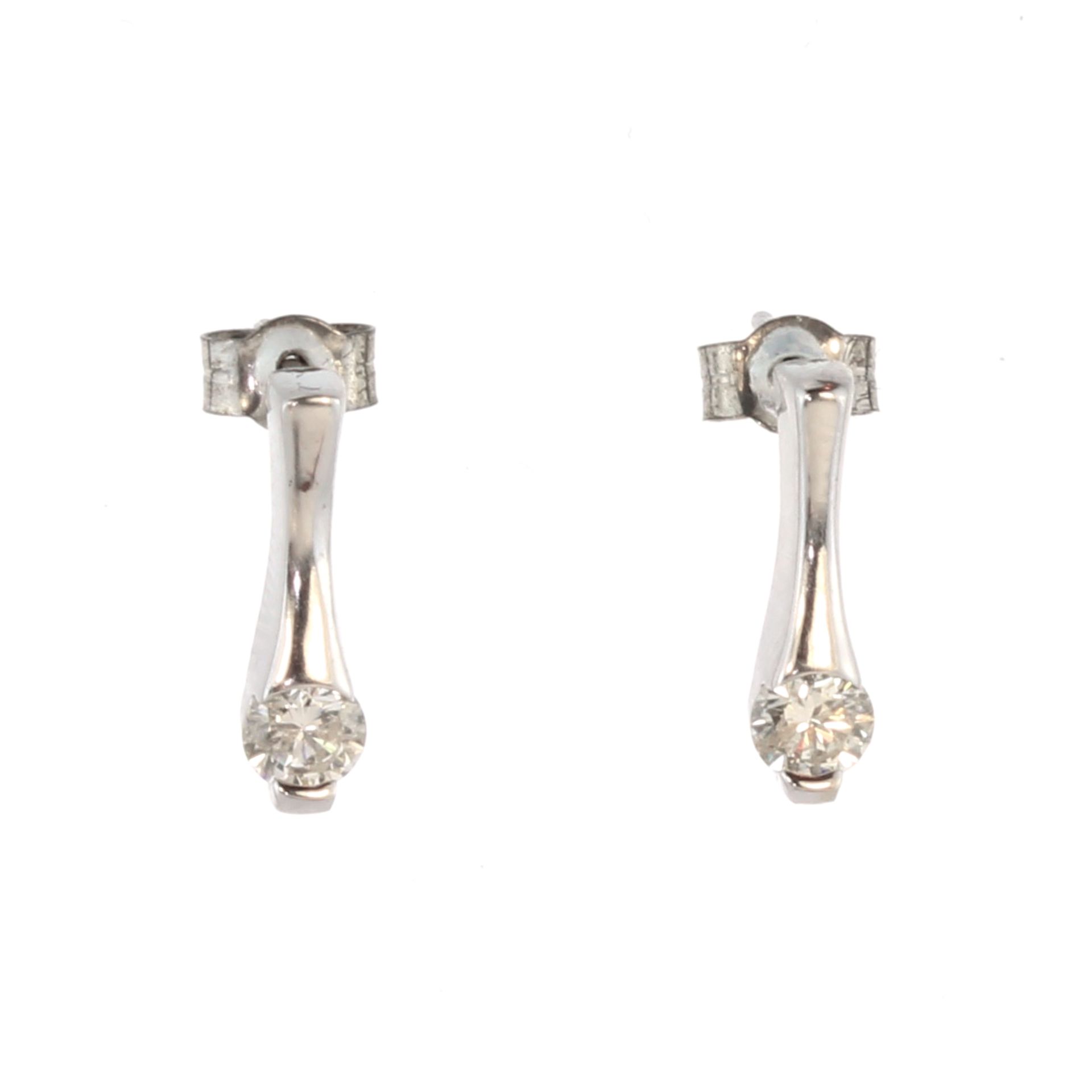 A pair of diamond drop earrings in 18ct white gold each set with a round cut diamond of