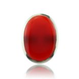 A large carnelian dress ring in sterling silver set with a large oval carnelian cabochon measuring