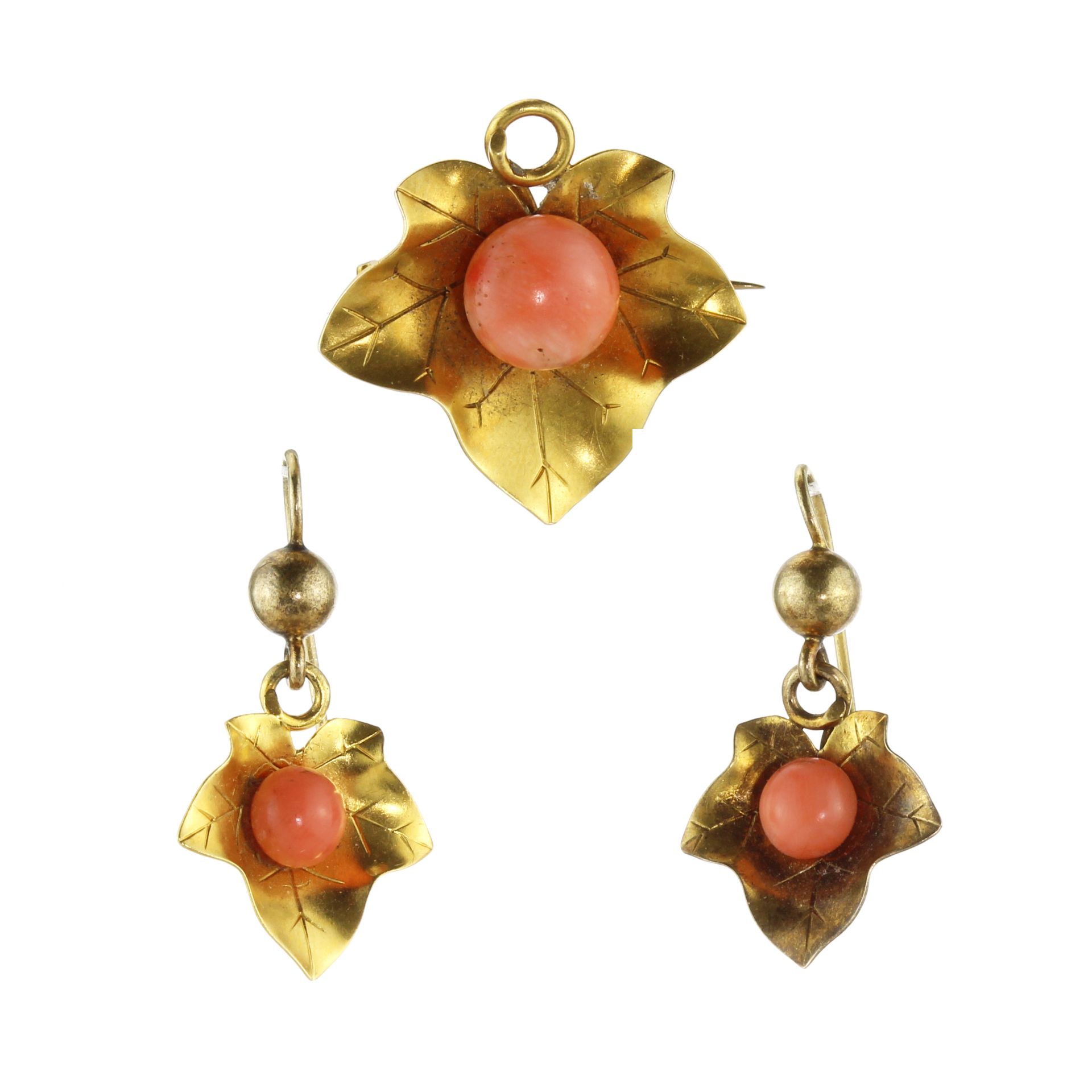 An antique 19th Century coral pendant / brooch and earrings suite in high carat yellow gold