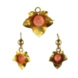 An antique 19th Century coral pendant / brooch and earrings suite in high carat yellow gold