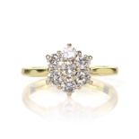 A diamond cluster dress ring in 18ct yellow gold set with seven round cut diamonds in a flower