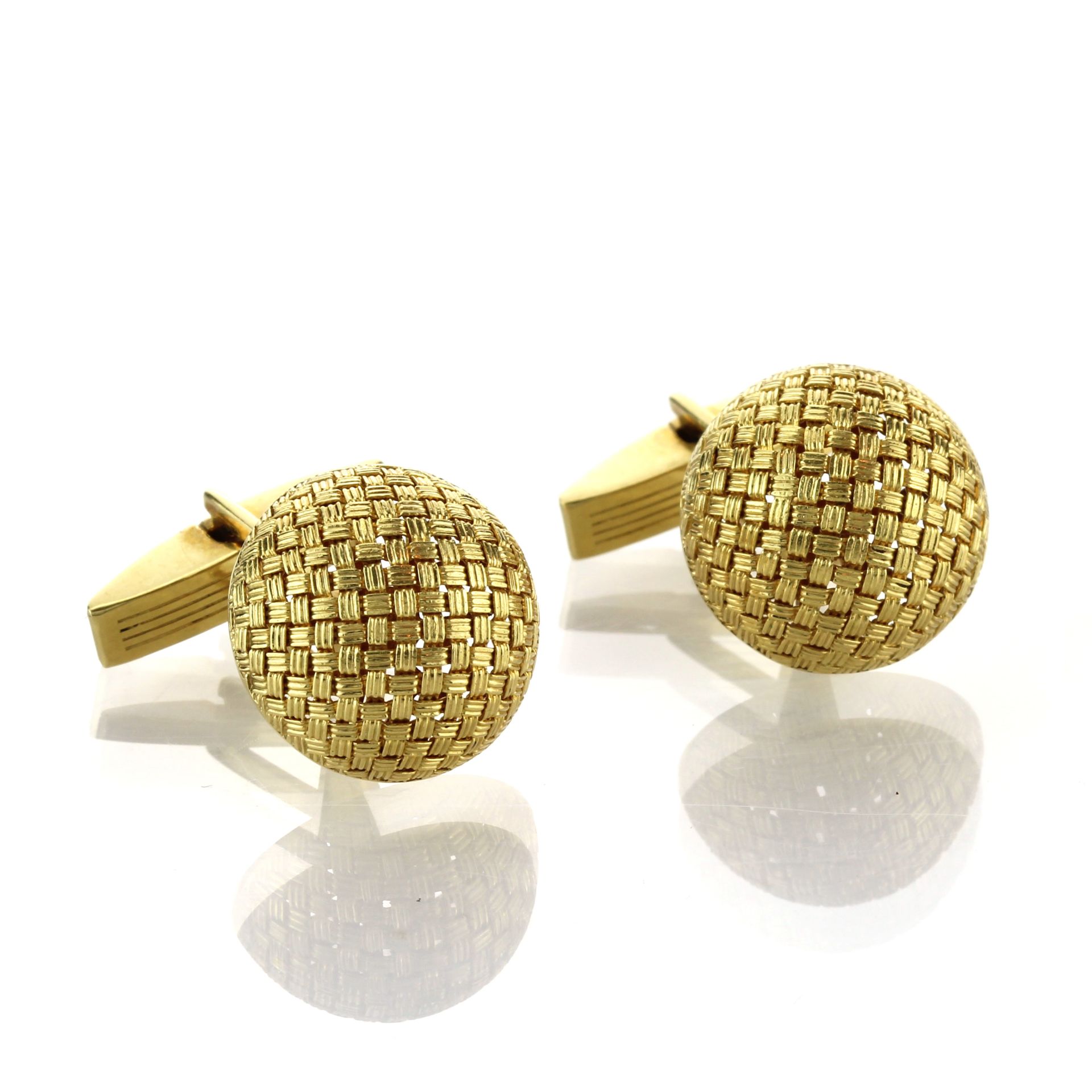 A pair of basketweave cufflinks in 18ct yellow gold each designed as a large, rounded link with