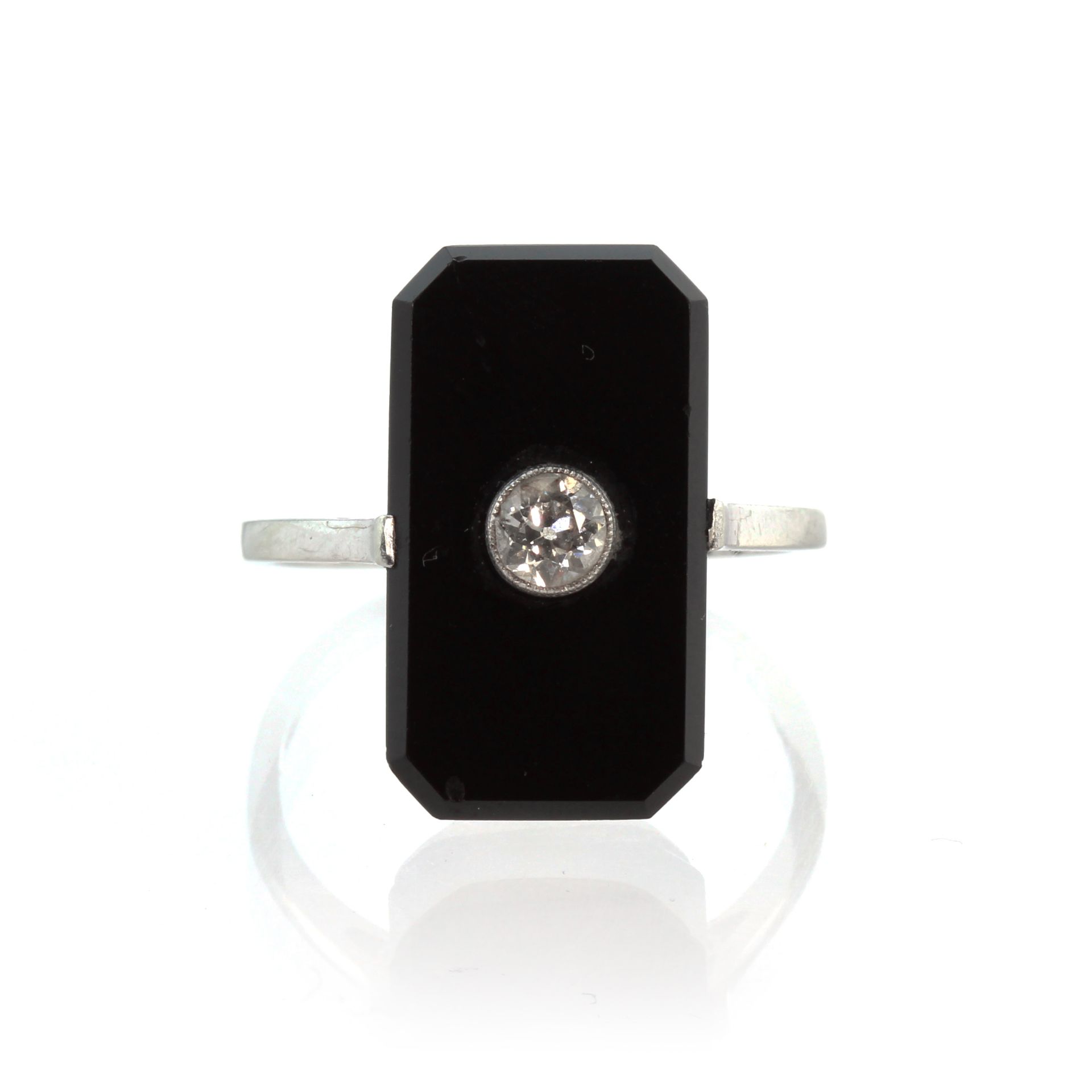 An antique Art Deco onyx and diamond dress ring in 18ct white gold and platinum designed as an
