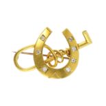 An antique novelty jewelled diamond racing brooch in high carat yellow gold designed as a horse shoe