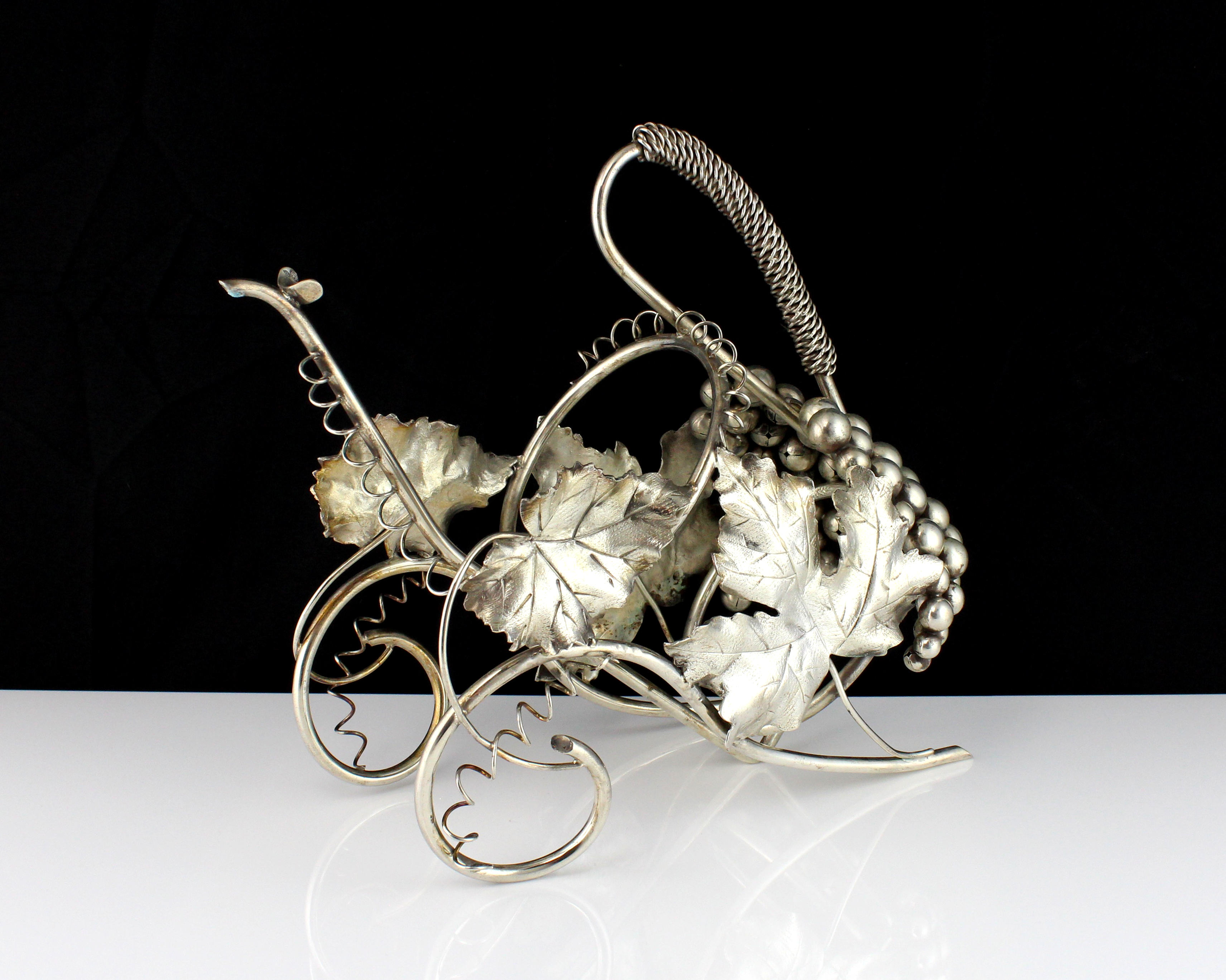 A vintage Italian 800 Silver wine bottle holder circa 1960. The wirework carriage body with