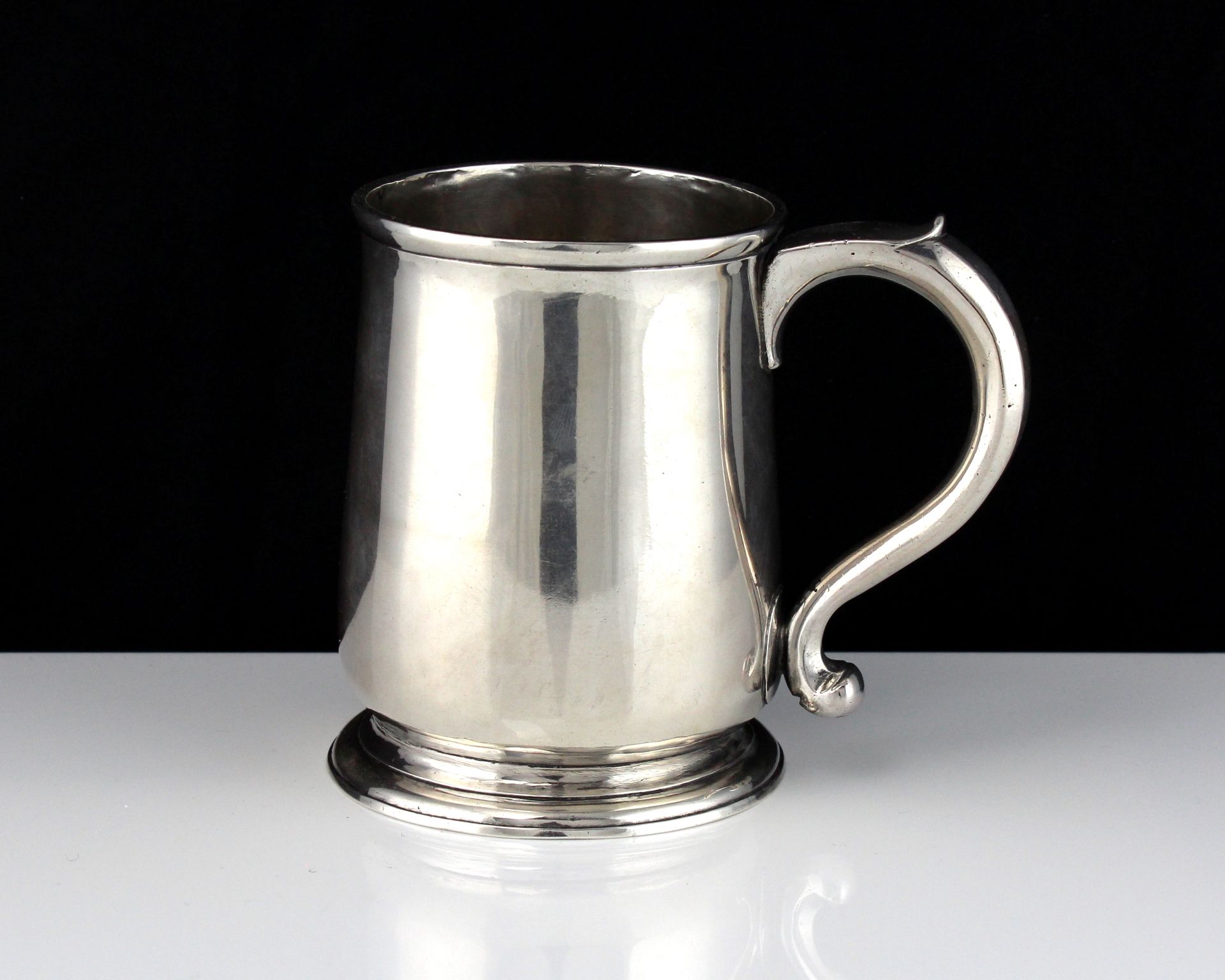 An antique George I Sterling Silver pint mug by Richard Green, London 1727 of baluster form on a