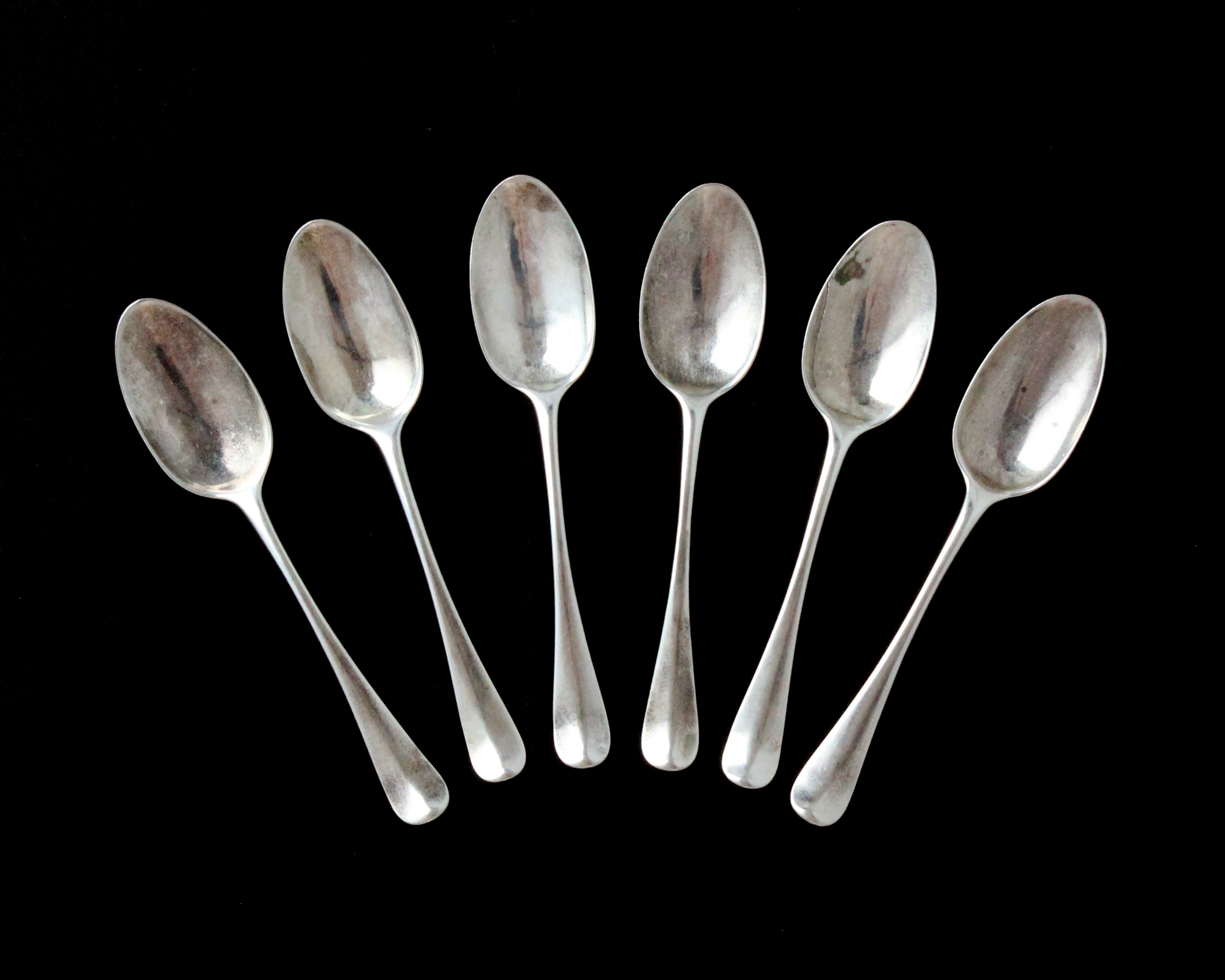 A set of six antique George II Sterling Silver dessert spoons by Philip Roker II, London 1730 in