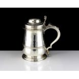 An antique George II Sterling Silver lidded tankard by John Swift, London 1750 of baluster form on a