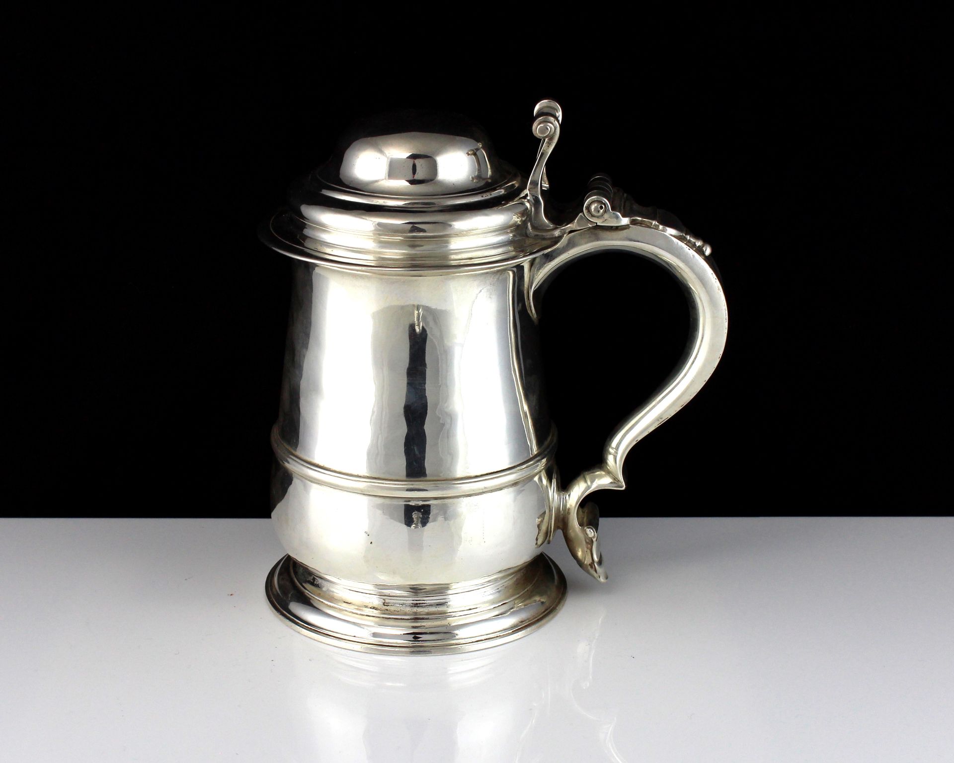 An antique George II Sterling Silver lidded tankard by John Swift, London 1750 of baluster form on a