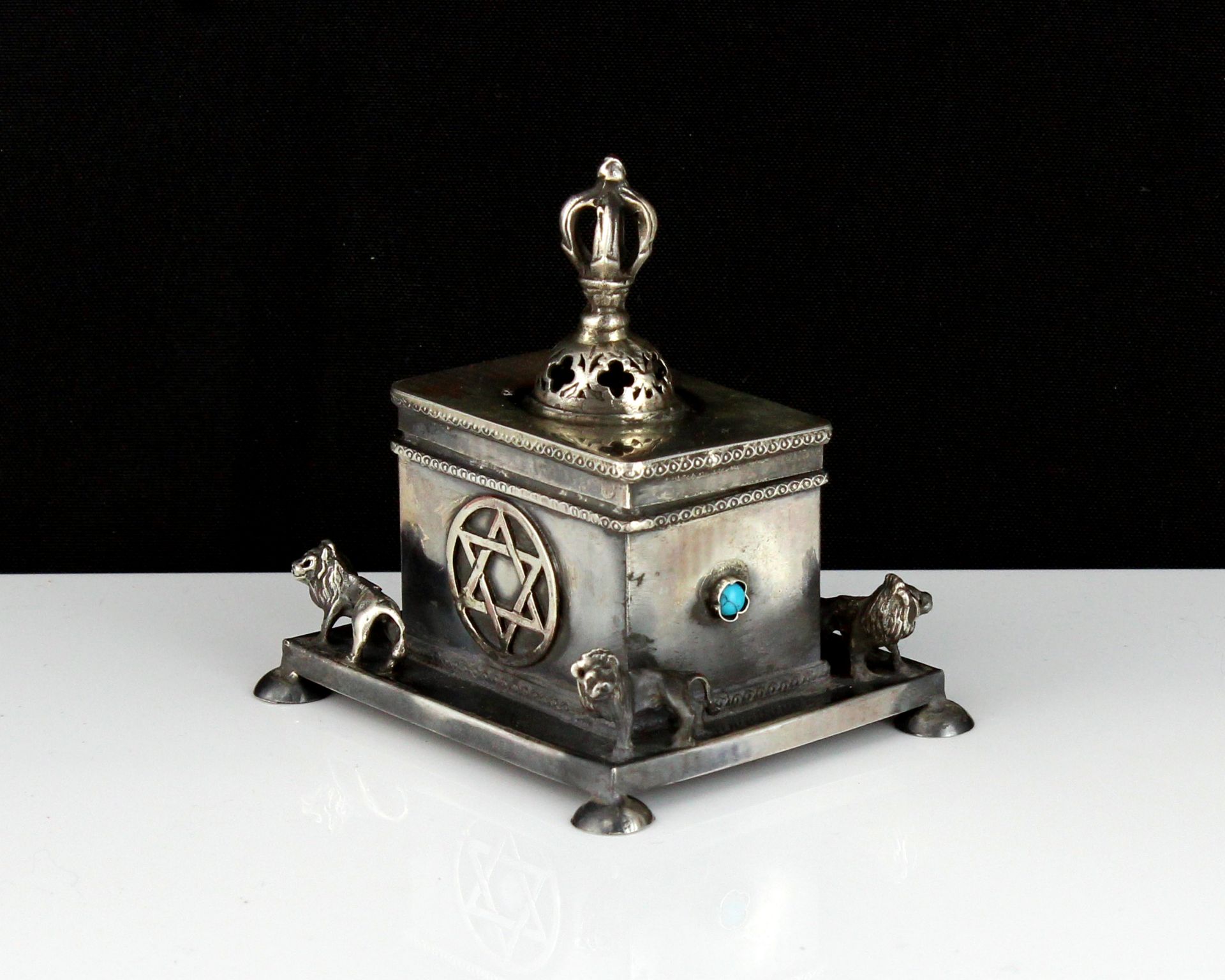 A jewelled silver Judaica box of rectangular form, on a larger base decorated with lions, raised