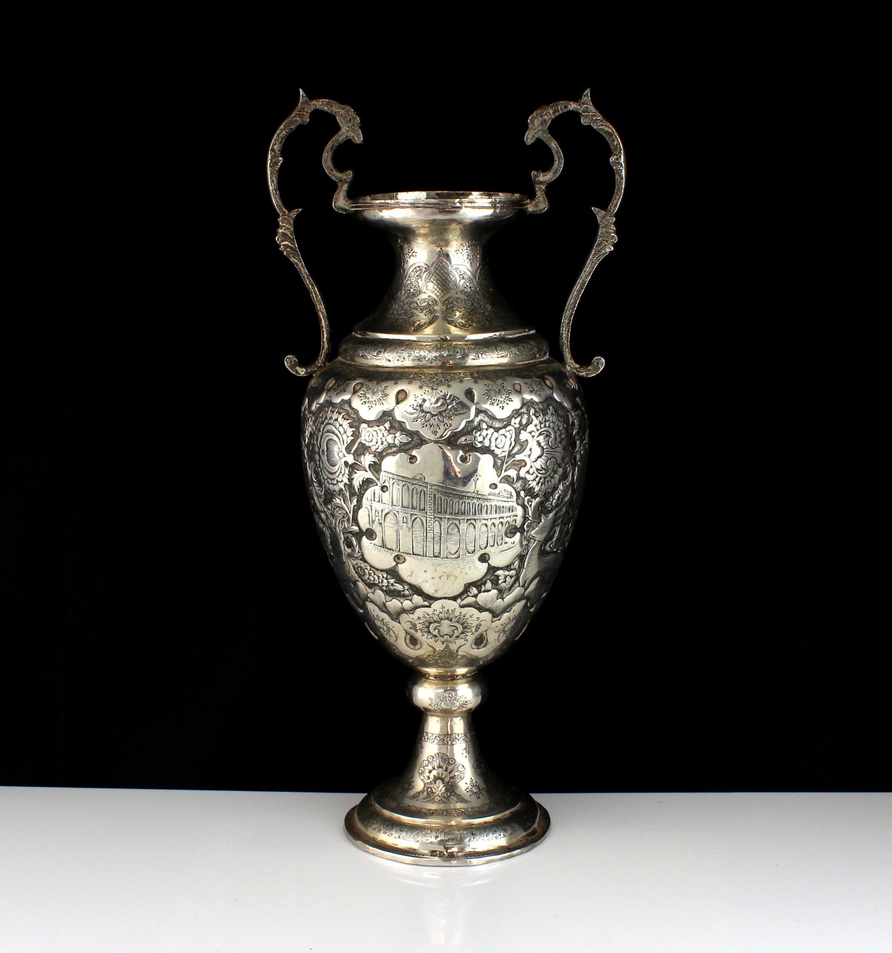 An antique late 19th Century Persian Silver vase of typical form, the rounded body on a pedestal