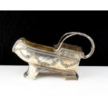 A French silver plated wine bottle holder, decorated with bound reeds and swags / garlands, with