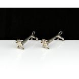 A pair of antique George V Sterling Silver sausage dog knife rests by Roberts & Dore Ltd,