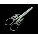 A pair of antique continental silver grape scissors with figural decoration to the handles,