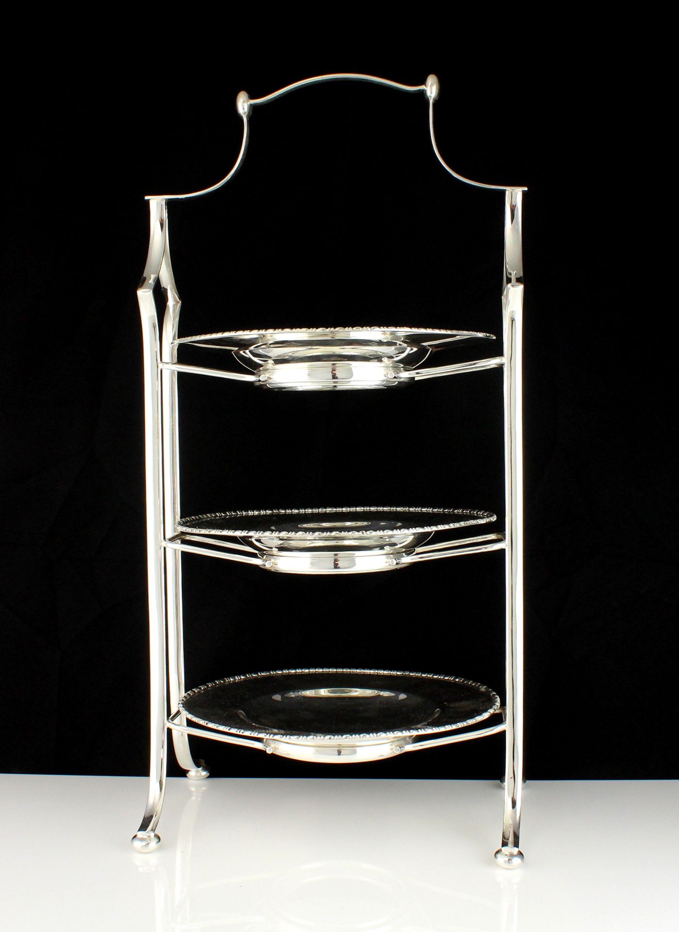 A large Silver plated cake stand designed with three tiers. Height 51cm / 20".