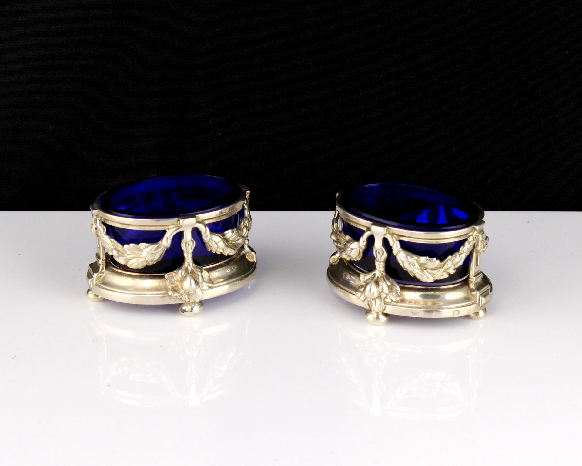 A pair of antique 19th Century French Silver salt cellars each of oval form, designed with