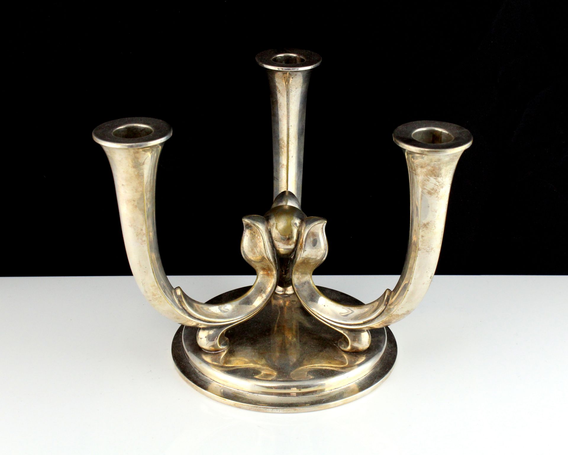 A WMF Silver plated candelabra designed as three tapering stems joined in the centre atop a circular