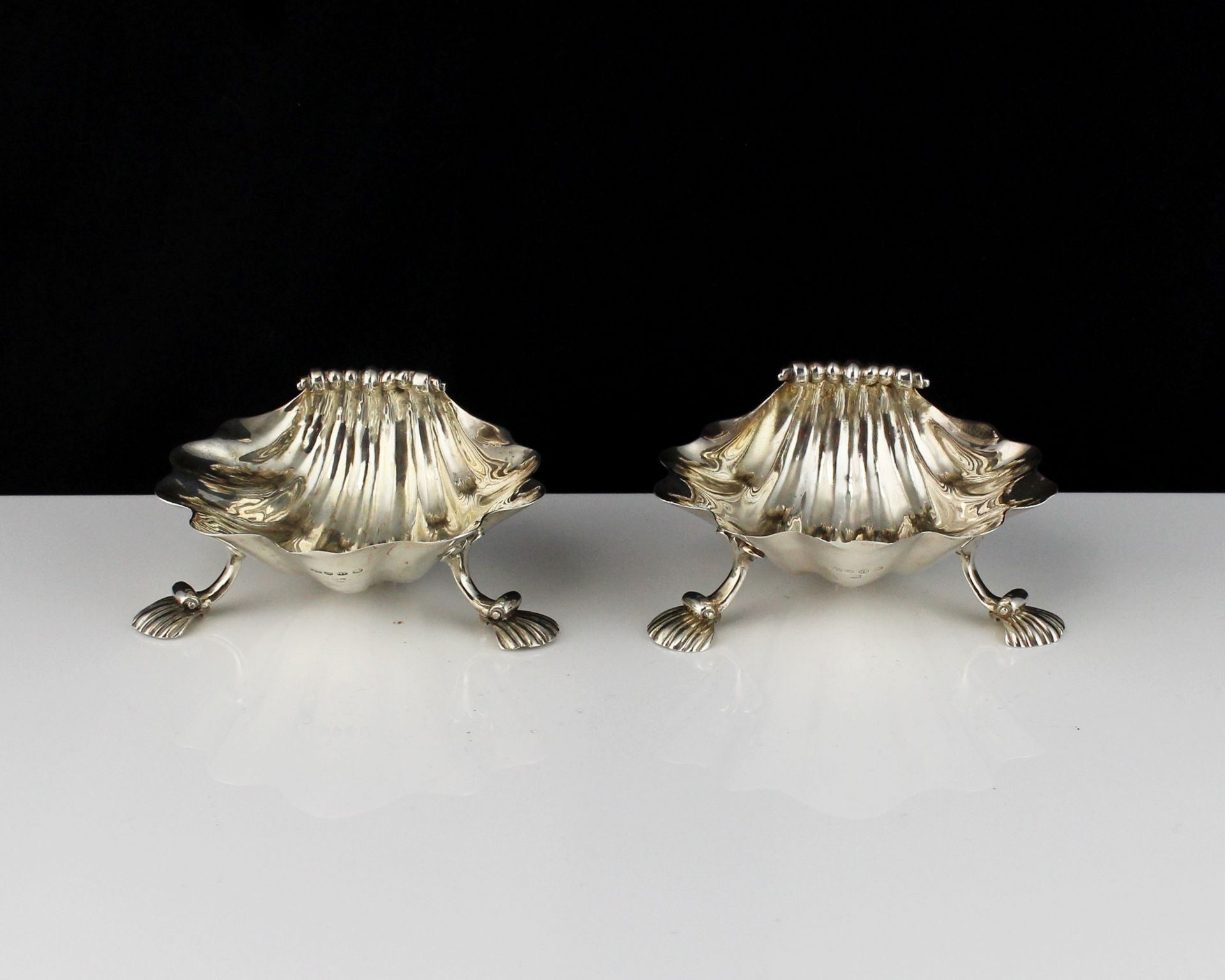 A pair of antique George IV Sterling Silver scallop shell salt cellars maker's mark Charles & John