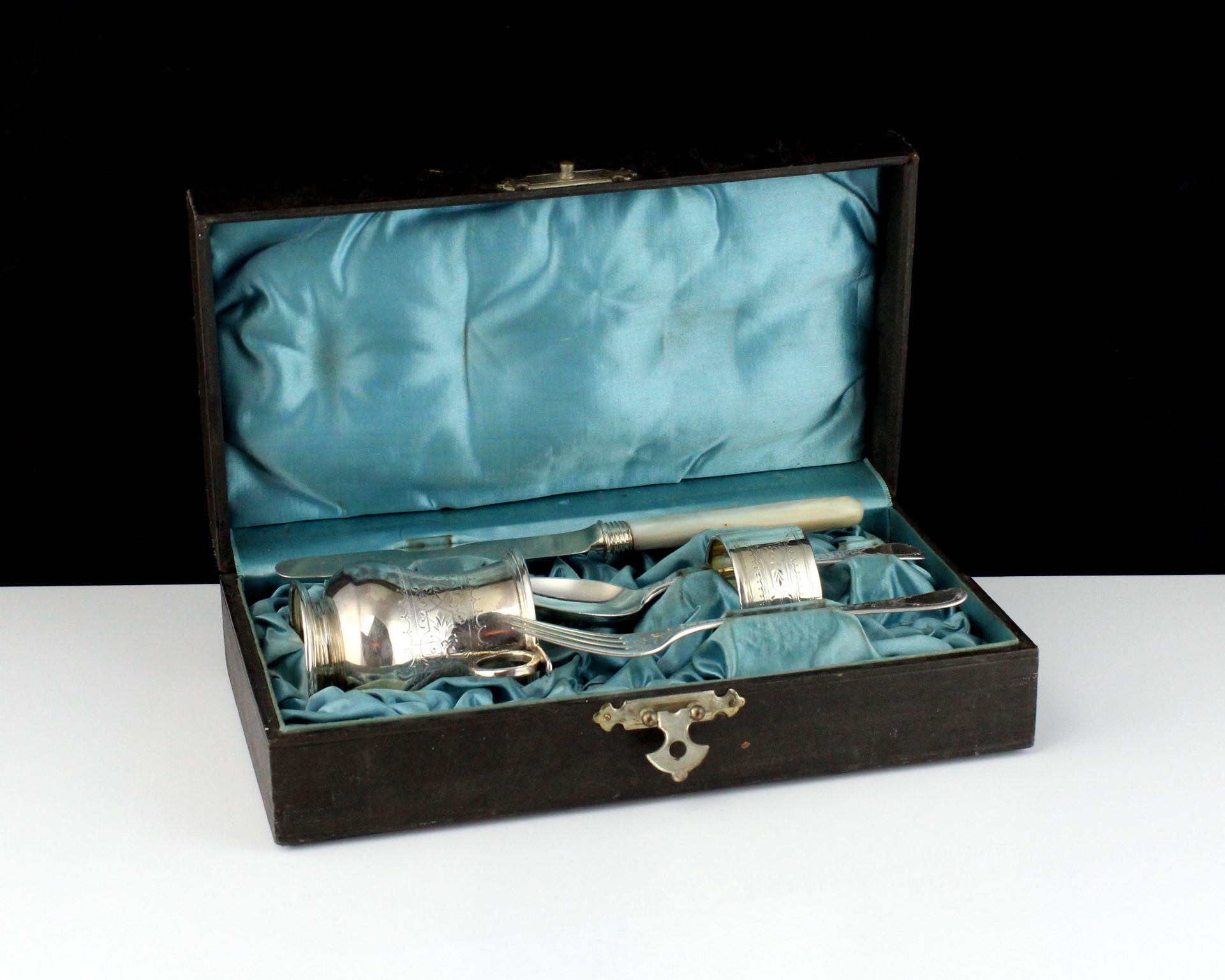 An antique continental Sterling Silver child's christening set comprising cup, napkin ring, spoon,