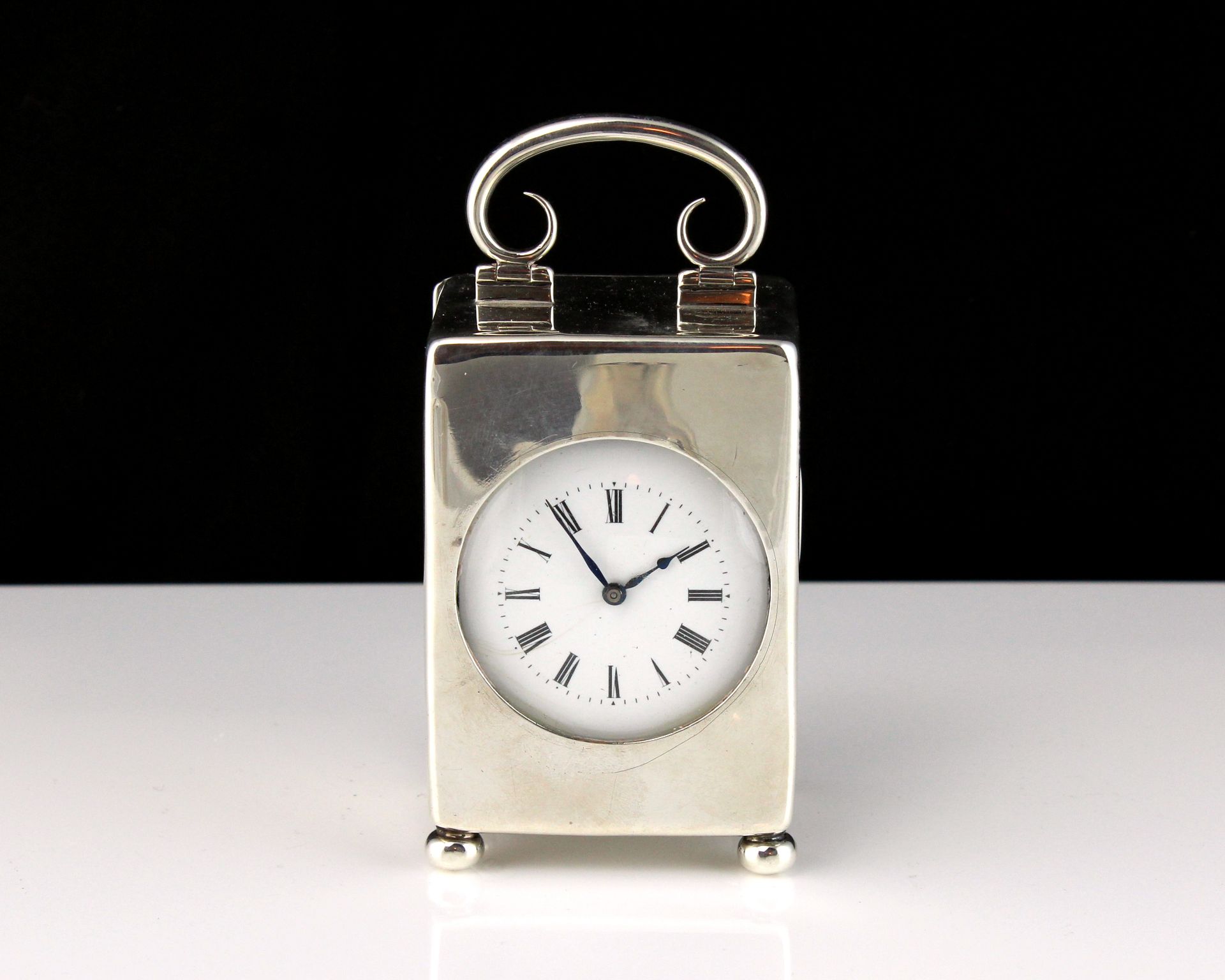 An antique Edwardian Sterling Silver carriage clock by William Comyns, London 1905. Of upright,