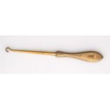 An antique 9ct yellow gold button hook by Mappin & Webb, the gold handle with finely engine turned