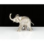 A sterling silver statue of an elephant designed in detail with its trunk raised. Length 10cm /