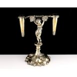 An antique Elkington & Co Silver plated table centrepiece designed as a cherub supporting two vase