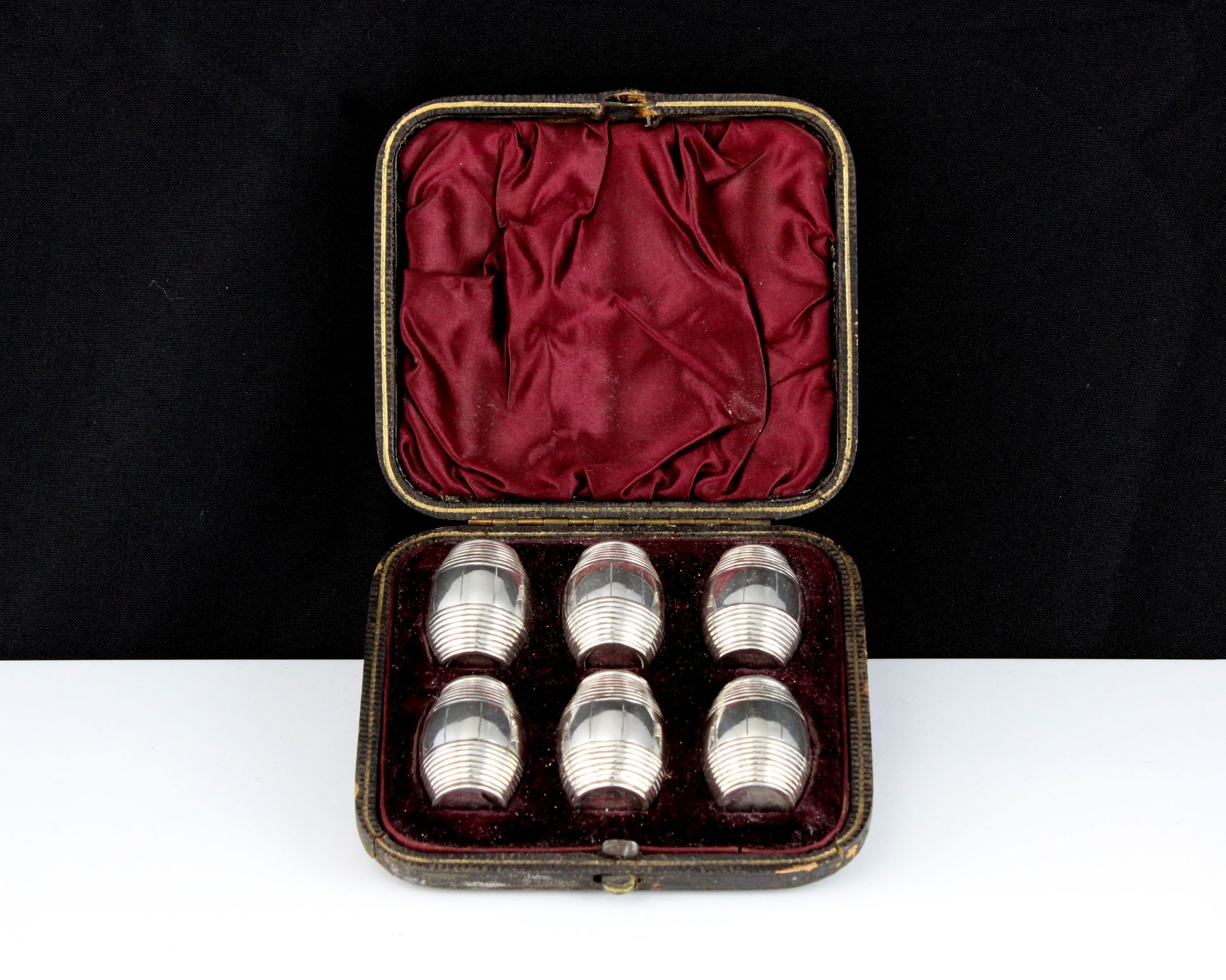 A set of six novelty antique Silver barrel pepperettes each designed as a wooden barrel with pierced