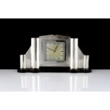 An Art Deco style German Silver mantel clock the geometric body with panels of engine turned