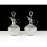 A pair of antique Victorian Sterling Silver mounted oil and vinegar jugs by the Betjemann