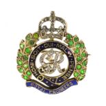 A DEMANTOID GARNET AND ENAMEL ROYAL ENGINEERS CAP BADGE / BROOCH, CIRCA 1920 designed as the Order