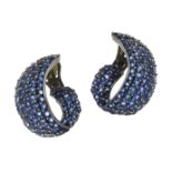 A PAIR OF SAPPHIRE CLIP EARRINGS the scrolling body of each jewelled all over with round cut blue