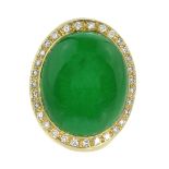 A JADEITE JADE AND DIAMOND COCKTAIL RING set with an oval cabochon jade of 65.4 carats, encircled by