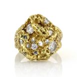 A GRIMA STYLE DIAMOND DRESS RING designed as a naturalistic gold face set with fourteen diamonds,